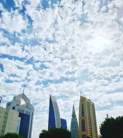 Low angle view of buildings against cloudy sky