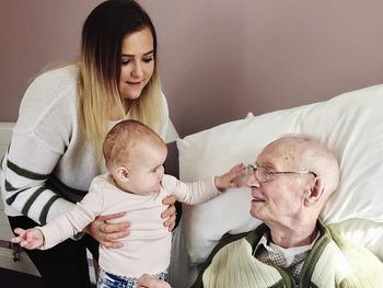 Portrait of mother and son with great great grandfather. uk