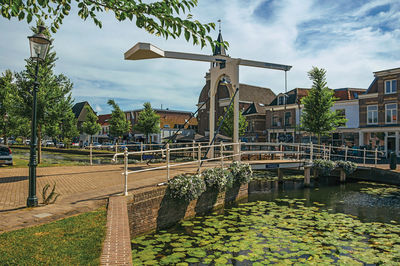 Canal amidst buildings against sky