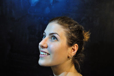 Portrait of smiling young woman looking away