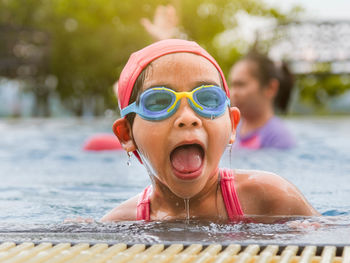 Portrait of boy swimming in pool