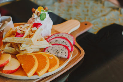 Close-up of fruits in plate on table