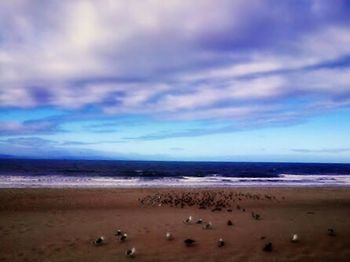 Scenic view of sea against cloudy sky