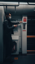 Man wearing mask standing in train