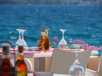 Close-up of drink on table against sea