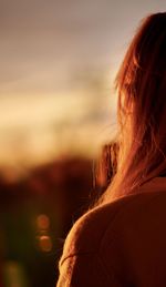 Rear view of woman looking at sunset