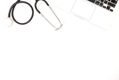 High angle view of eyeglasses on table against white background