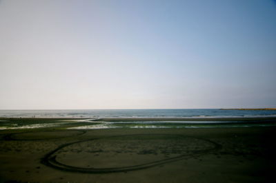 Scenic view of beach against clear sky