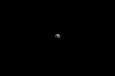 Low angle view of half moon against black sky