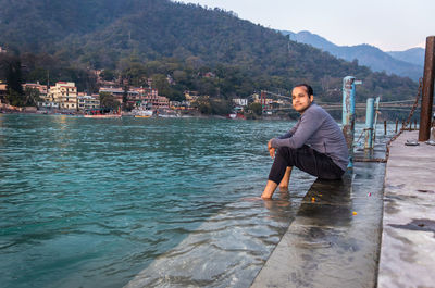 Portrait of young man standing in river