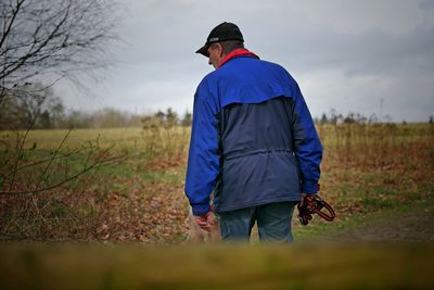 Rear view of man standing on field