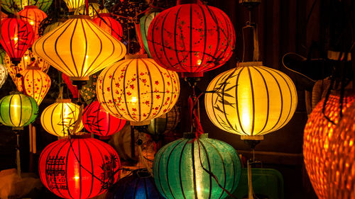 Low angle view of illuminated lanterns hanging at night