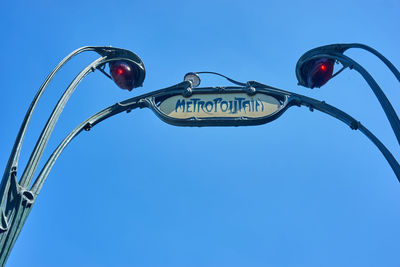 Low angle view of street light against clear blue sky