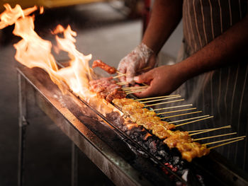 Cooking barbeque satay in the street