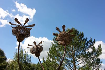 Low angle view of trees against blue sky