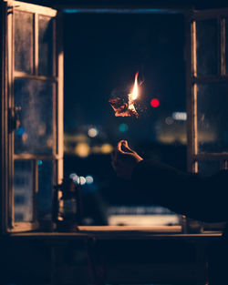 Person holding burning candles
