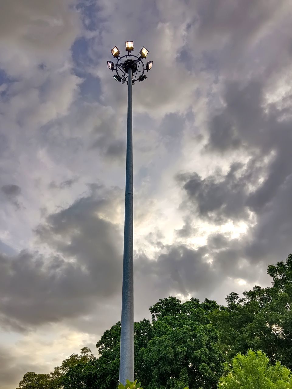 cloud, street light, sky, nature, plant, lighting equipment, low angle view, lighting, light fixture, tree, street, no people, outdoors, floodlight, architecture, cloudscape, day, environment, pole, light, wind, tower, storm