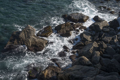 High angle view of rocks by sea