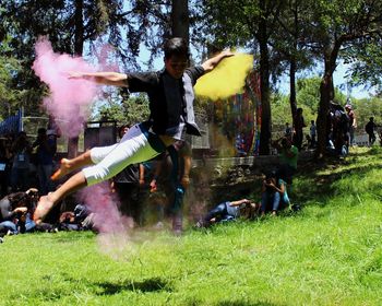View of people jumping on grass