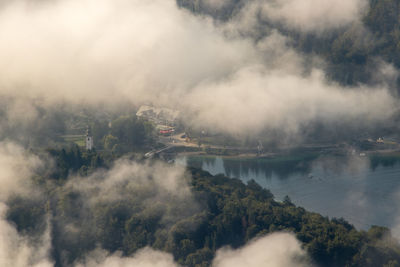 High angle view of trees and lake during foggy weather