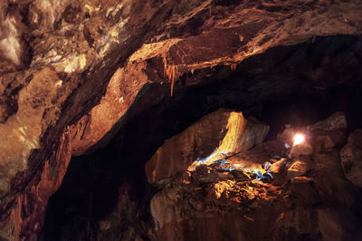 Bonfire by rock formation at night