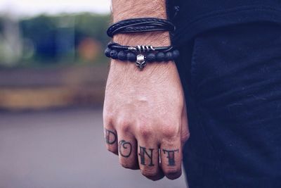 Cropped hand of man with tattoo