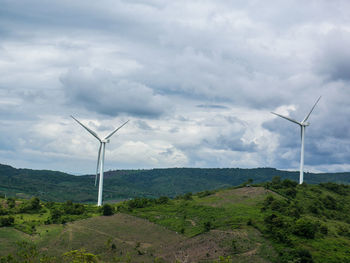 Windmill on field against sky