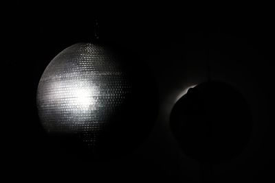 Close-up of illuminated light bulb in darkroom