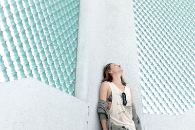 Woman standing against wall