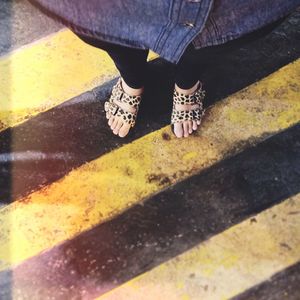 Low section of man standing on tiled floor