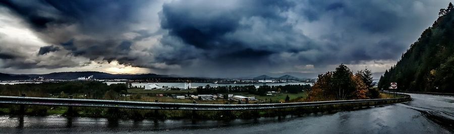 Panoramic view of bridge over canal against cloudy sky