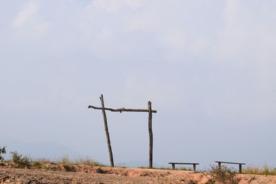 Windmills on field against sky