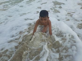 High angle view of boy playing at beach