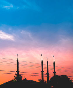 Low angle view of silhouette trees against sky at sunset
