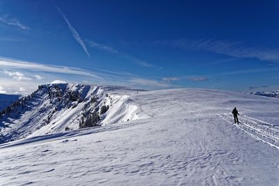 Scenic view of snowcapped mountains against sky during winter