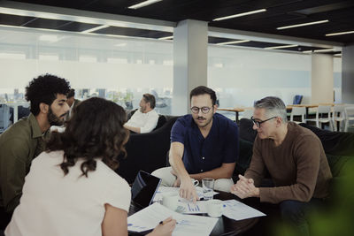 Group of business people having meeting in lobby