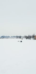 Scenic view of snow covered field against clear sky