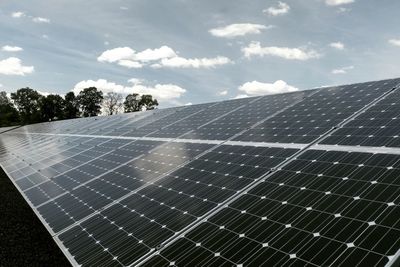 Solar panels on ground against sky