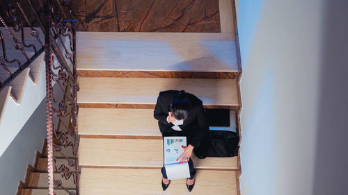 Rear view of woman standing by railing