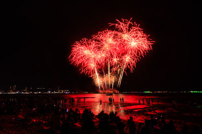 Low angle view of firework display at night