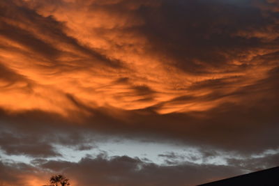 Low angle view of cloudy sky at sunset