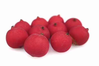 Close-up of cherries against white background