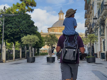 Rear view of man walking on street