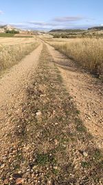 Empty road along countryside landscape