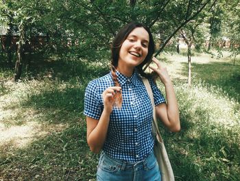 Portrait of a young woman sitting on grass