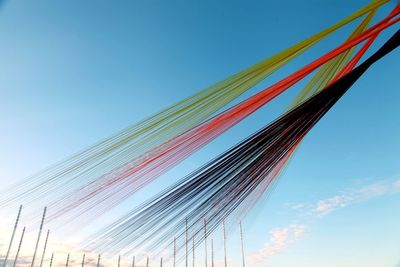 Low angle view of multi colored wall against blue sky