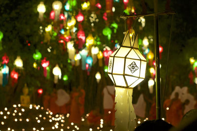 Close-up of illuminated lighting equipment hanging on tree