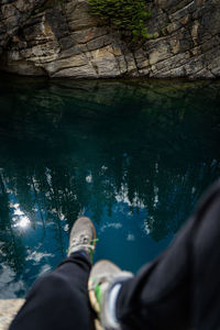 Picture of legs dangling over water