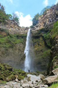 View of waterfall against rocks