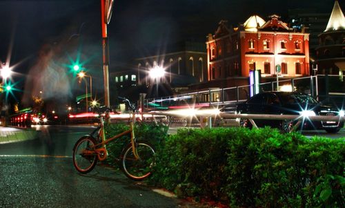 Cars parked on road at night